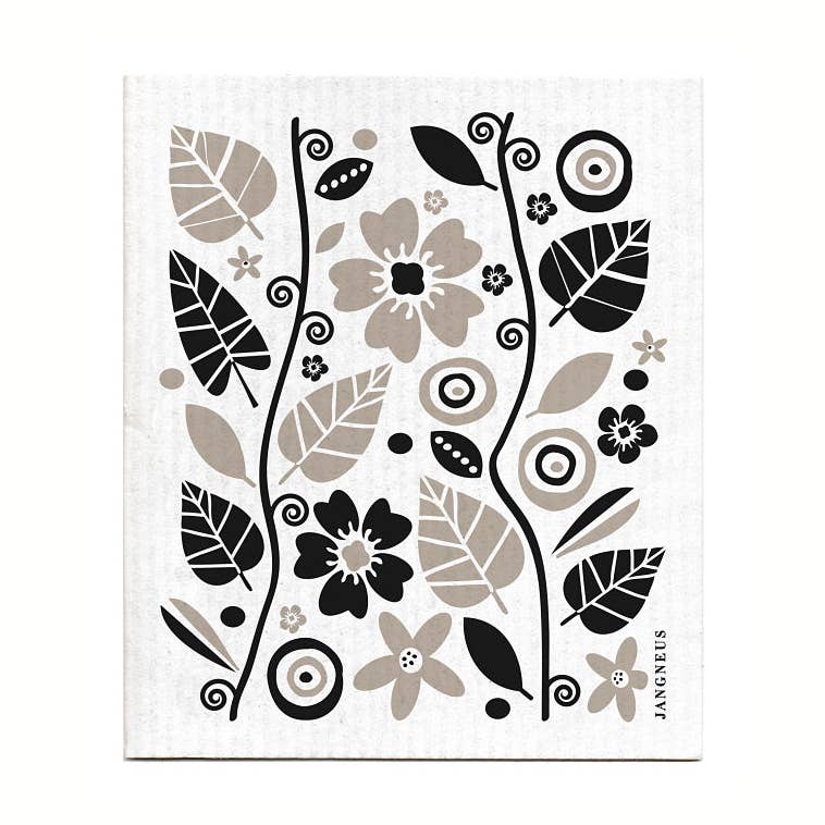 The Garden Black Gift Set includes a tea towel and dish cloth featuring black and beige floral and abstract designs on white, ideal for sustainable kitchen use.