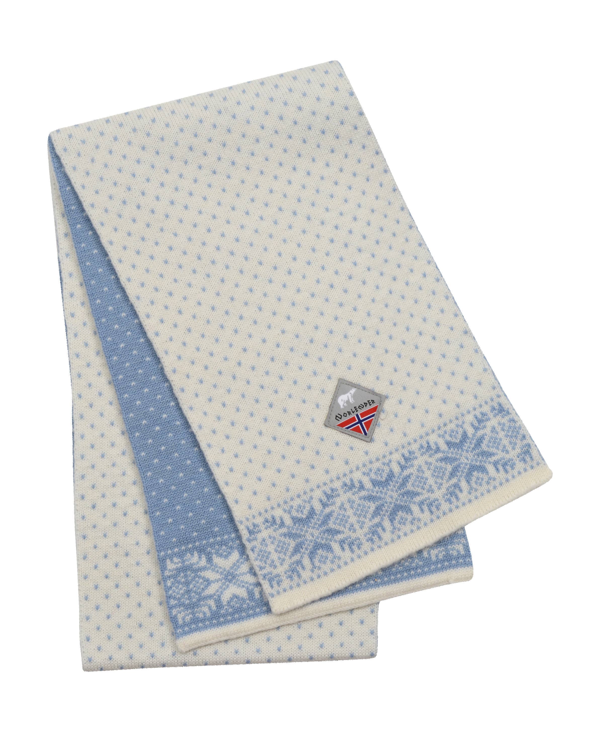 The Snowflake White and Blue scarf by Norlender Knitwear, crafted from Norwegian wool with a traditional design, features a folded pattern and a small diamond-shaped tag adorned with a flag.