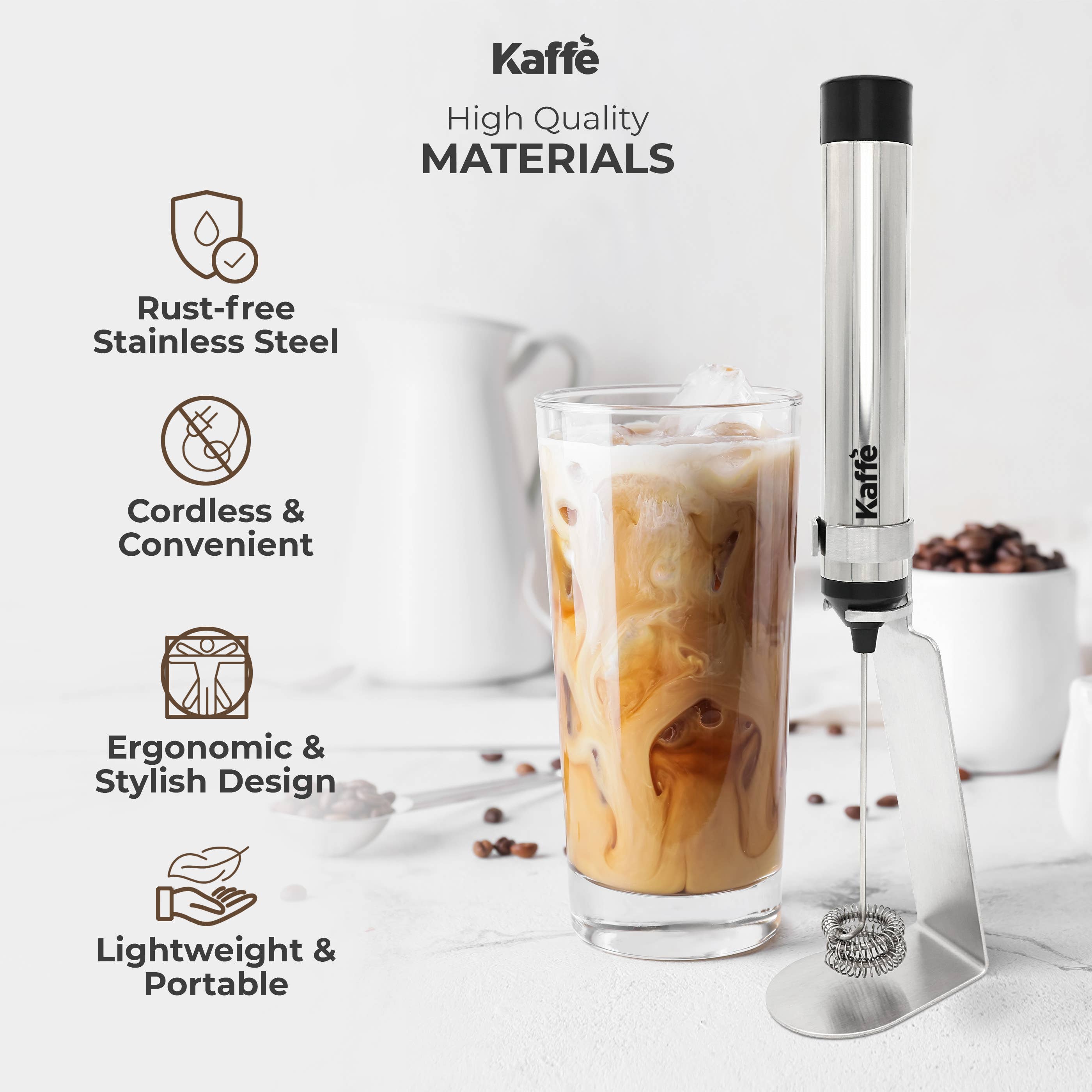 The Kaffe Handheld Milk Frother with Stand (USB Rechargeable, Stainless Steel) is displayed next to a glass of iced coffee, highlighting its features and benefits.