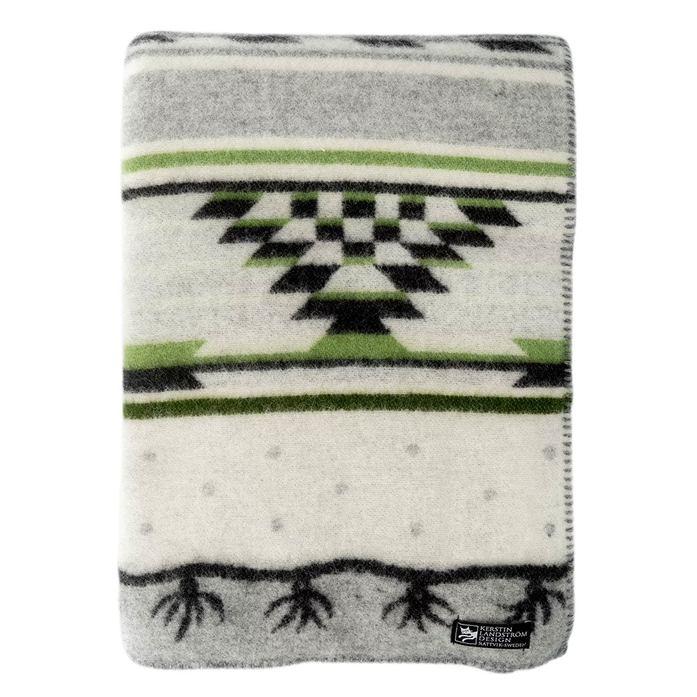 The folded Sundborn blanket by Kerstin Landstrom, made of 100% Norwegian lambs wool, showcases a geometric green, black, and gray pattern on white. A small corner label certifies it as OEKO-TEX-certified.