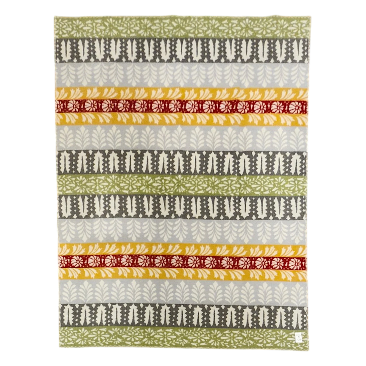 Swedish design blanket with green, gray, yellow, and red horizontal stripes and leaf and floral patterns on a white background.