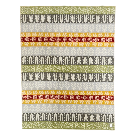 Swedish design blanket with green, gray, yellow, and red horizontal stripes and leaf and floral patterns on a white background.