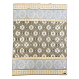 Swedish wool blanket in yellow, gray, and cream with horizontal bands of geometric and floral patterns.