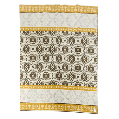Rectangular lambswool blanket featuring yellow, brown, and white geometric and floral patterns, with yellow borders displaying white floral motifs.