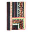 Bunad blanket with orange, black, green, and cream stripes, floral patterns, contrasting borders, and a turned-up corner showing the underside.