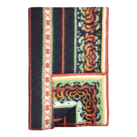 Bunad blanket with orange, black, green, and cream stripes, floral patterns, contrasting borders, and a turned-up corner showing the underside.