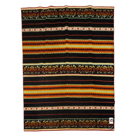 Rectangular Bunad blanket with horizontal stripes in black, orange, yellow, and red, decorated with detailed floral and geometric patterns.