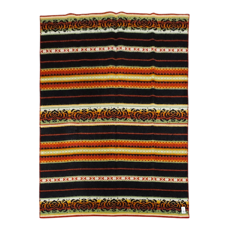 Striped Bunad blanket with black, red, yellow, and orange bands, detailed woven patterns, and a small label sewn onto the bottom right corner.