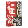 Folded red and white lambswool blanket featuring animal, heart, and geometric patterns, Swedish Dala horses, and green trim.