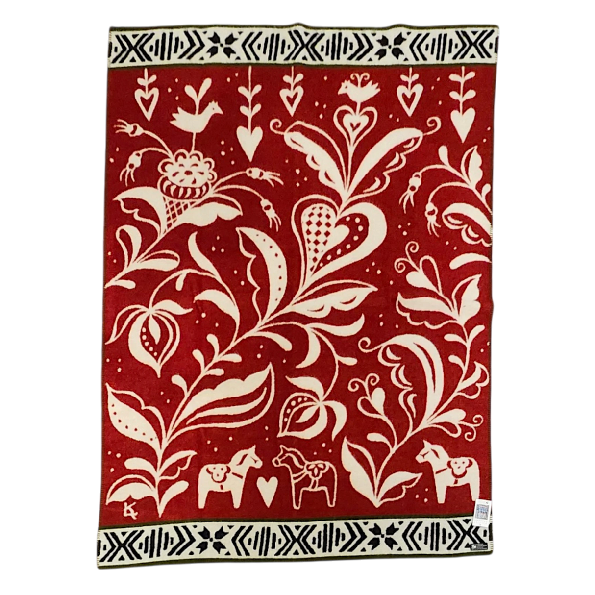 Red and cream lambswool blanket featuring Scandinavian folk art, Swedish Dala horses, stylized flowers, birds, and black-and-white geometric borders.