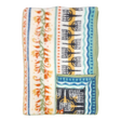 Folded fleece blanket with green trim, orange floral and blue geometric patterns on a cream background, showing Swedish-inspired design.