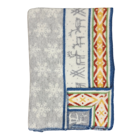 Folded Sámi-inspired wool blanket featuring a gray snowflake pattern, blue border, and one side with geometric and stripe designs in orange, yellow, and blue.