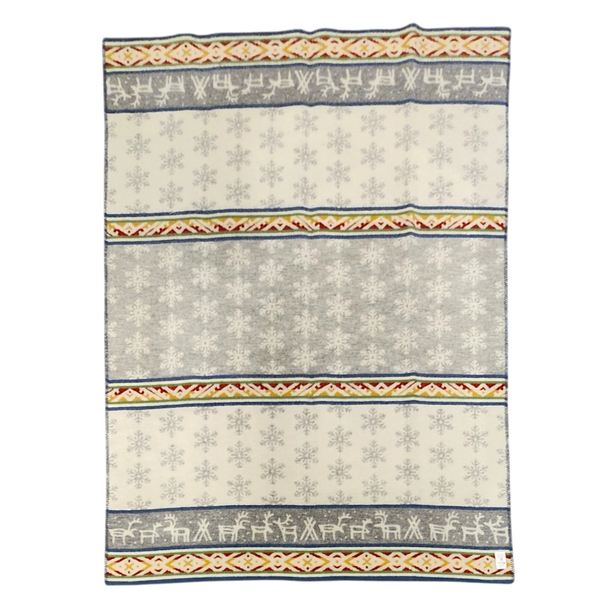 Wool blanket with Sámi-inspired rows of reindeer, snowflakes, and geometric patterns in gray, white, yellow, and red.