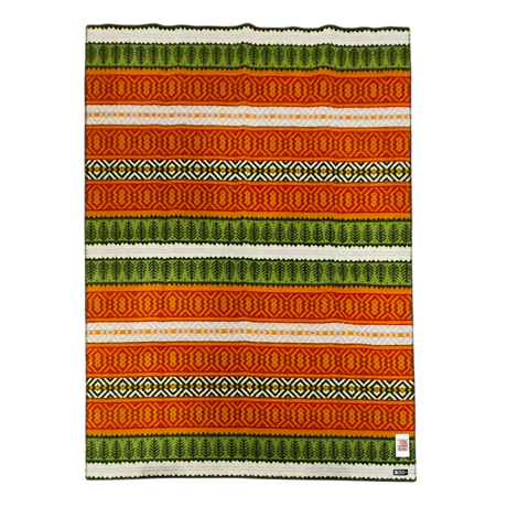 Lambswool blanket with horizontal orange, green, yellow, and white stripes, featuring geometric and zigzag patterns. Small white tag in one bottom corner.