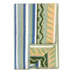 Folded fleece blanket in a Swedish design featuring green, blue, and cream stripes with wavy patterns; one corner is turned over to display the reverse side.