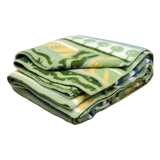 Folded wool blanket featuring yellow and blue patterns on a white background.