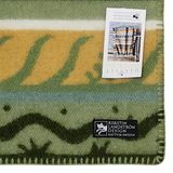 Lambswool blanket with green, beige, and blue stripes. Two visible labels: one product tag and one reading “Kerstin Landström Design Rättvik, Sweden.”.