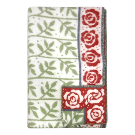 Swedish design blanket featuring green leaf pattern and red rose border on white background; one corner flipped to show reverse side.