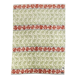 Swedish-style blanket with green leafy vine patterns and three horizontal rows of red roses on a white background.