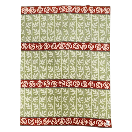 Green blanket with a white leaf pattern and three horizontal red bands, each featuring a row of white roses. Swedish design elements are visible.