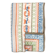 Folded wool blanket with blue, orange, green, and beige animal, floral, and geometric patterns inspired by Swedish folk art, brown trim visible along the edge.