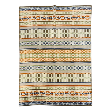 Rectangular lambswool blanket with horizontal orange, black, and beige stripes, showing Swedish folk art-inspired geometric and floral patterns.