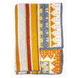 A folded Swedish blanket with yellow, orange, white, and gray stripes and geometric patterns; one corner is turned up to show the reverse side.
