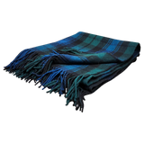 Folded Black Watch tartan blanket featuring blue, green, and black stripes with fringe on the edges, shown on a white background.