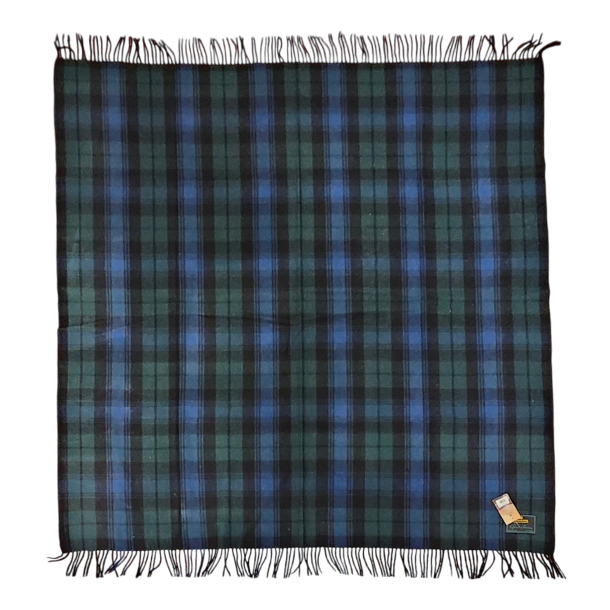 Square Black Watch tartan blanket featuring dark green and blue plaid pattern, fringed edges, and a small fabric tag sewn into one corner.