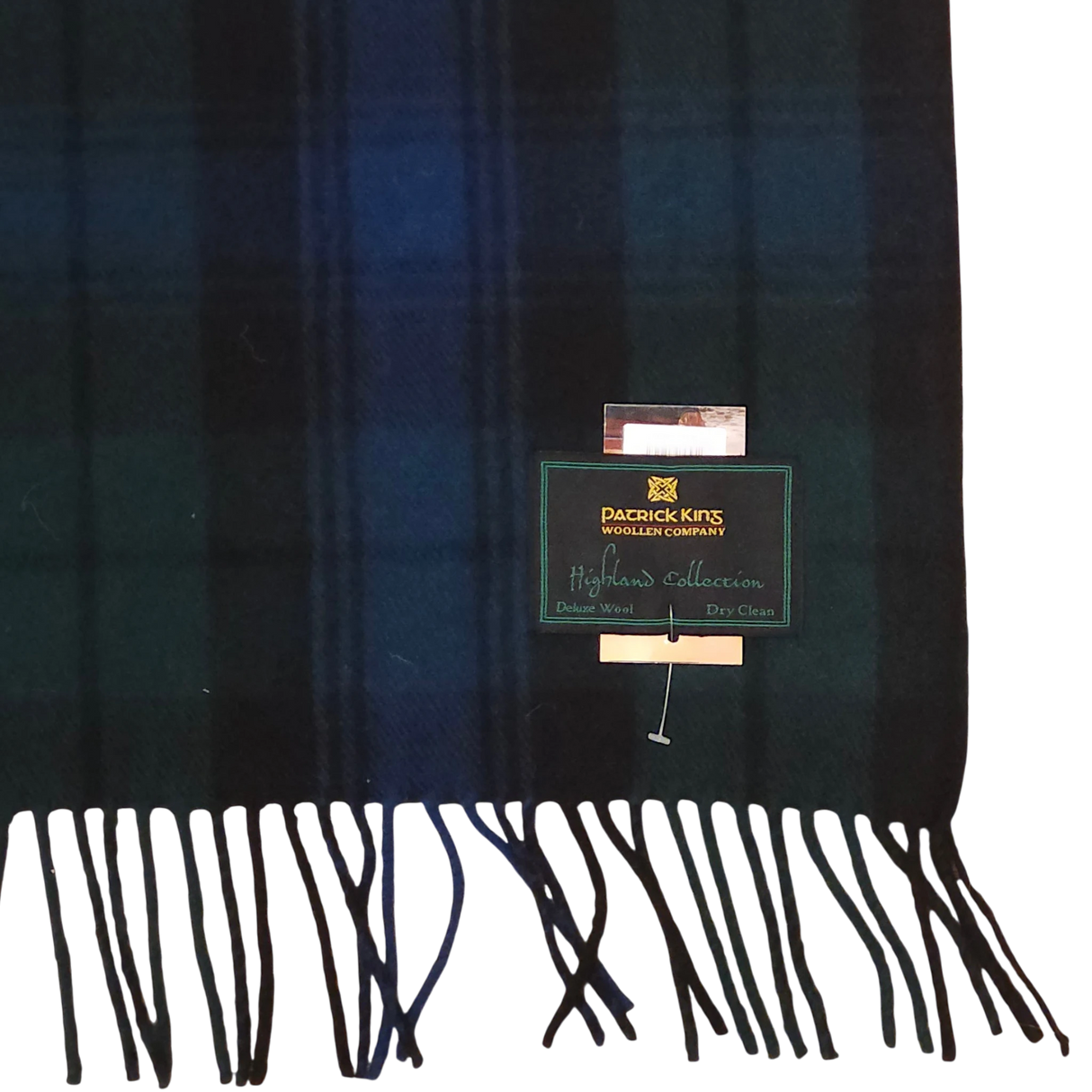 Wool scarf with dark green and navy Black Watch tartan, fringed ends, and a visible Patrick King Woollen Company Highland Collection label.