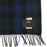Wool scarf with dark green and navy Black Watch tartan, fringed ends, and a visible Patrick King Woollen Company Highland Collection label.