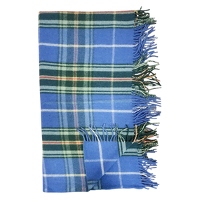 Folded Highland tartan blanket with green, white, and yellow stripes and fringed edges on a white background.