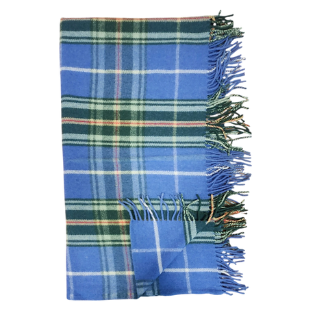 Folded Highland tartan blanket with green, white, and yellow stripes and fringed edges on a white background.