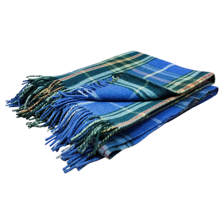 Folded blue and green Scottish tartan blanket with fringed edges on a white background.