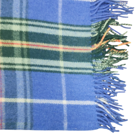 Blue Highland tartan blanket with green, white, and orange stripes and fringed edges, shown on the right side.