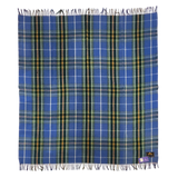 Blue Highland tartan blanket featuring yellow, white, and green stripes, fringed edges, and a label on one corner, laid flat on a white background.