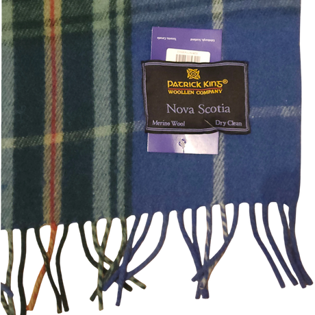 Blue and green Scottish tartan scarf with fringe, featuring a label that reads Patrick King Woollen Company, Nova Scotia, Merino Wool, and Dry clean only.