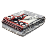 Folded gray Swedish wool blanket featuring a white leaf pattern and a red, black, and white star design along one edge.