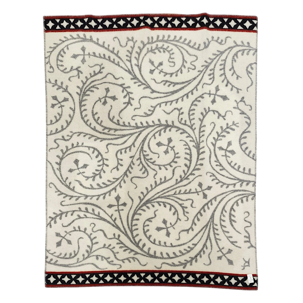 Cream wool blanket with gray swirling vine patterns and black and red geometric borders.