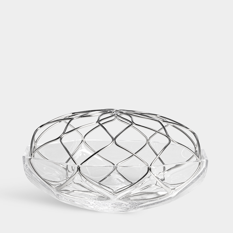 The Orrefors Bloom Vase Low features a clear glass bowl with a geometric pattern and a metal grid on top, showcased against a plain white background.