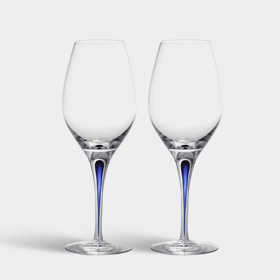 Set against a plain white background, the Orrefors: Intermezzo Blue Balance (2-Pack) features two elegant crystal wine glasses with long stems and subtle blue tints, showcasing their sophisticated and artistic mouth-blown design.