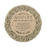 The Soap Lift: Round A Bout Soap Lift Soap Saver is a round, beige soap holder with a woven plastic texture and central label. It keeps soap dry, extends its life, is BPA-free, and serves as an eco-friendly soap saver.