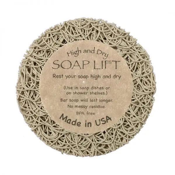 The Soap Lift: Round A Bout Soap Lift Soap Saver is a round, beige soap holder with a woven plastic texture and central label. It keeps soap dry, extends its life, is BPA-free, and serves as an eco-friendly soap saver.