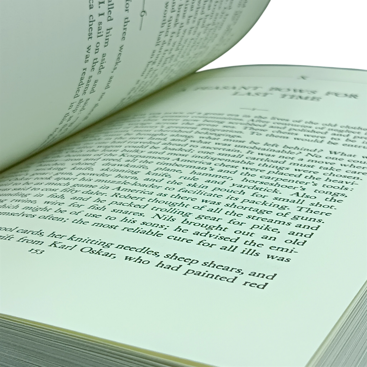 An open book with cream pages and black text, shown at an angle. The visible page references Swedish immigrants, knitting needles, and sheep shears.