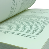 An open book with cream pages and black text, shown at an angle. The visible page references Swedish immigrants, knitting needles, and sheep shears.