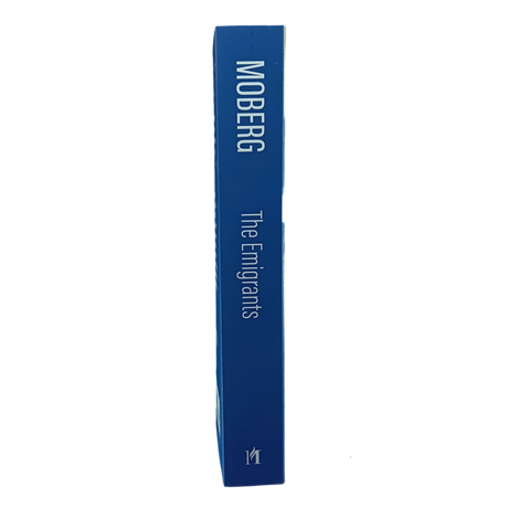 Blue hardcover book with spine text “The Emigrants Vilhelm Moberg” displayed upright against a plain white background.