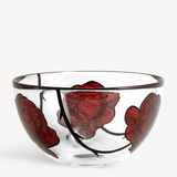 The KostaBoda Tattoo Bowl Large, designed by Ludvig Lofgren, features clear glass with a black rim, bold red floral designs, and hand-painted black stems decorating the exterior.