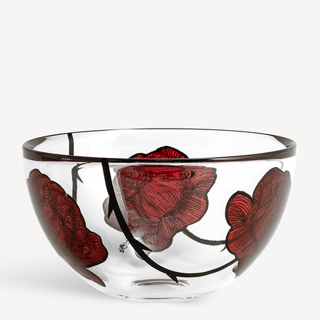 The KostaBoda Tattoo Bowl Large, designed by Ludvig Lofgren, features clear glass with a black rim, bold red floral designs, and hand-painted black stems decorating the exterior.