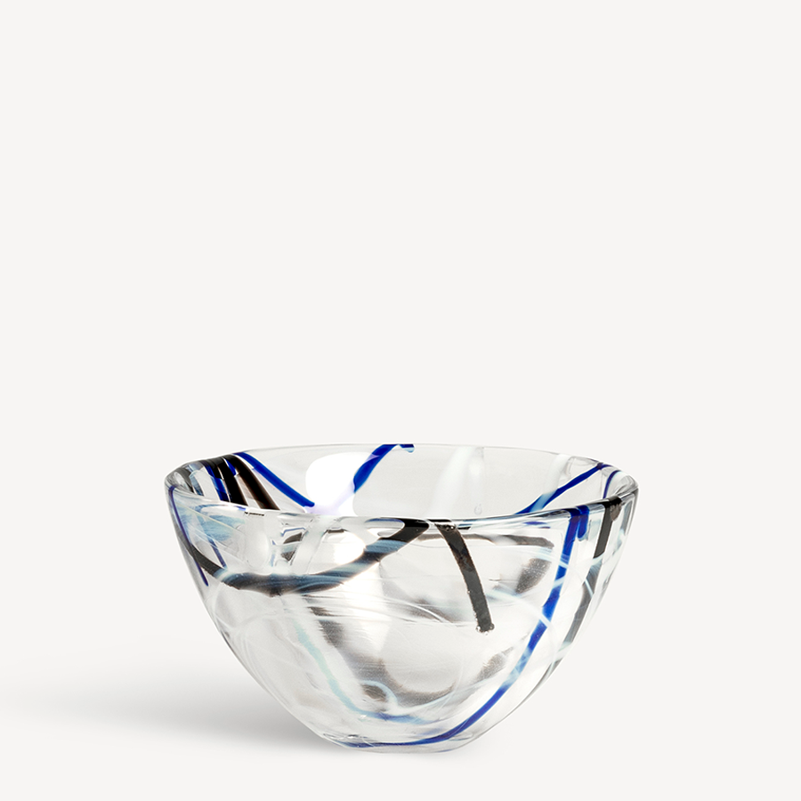 Designed by Anna Ehrner, the KostaBoda: Contrast White Bowl Small showcases a clear glass bowl with abstract blue and black swirl patterns against a plain white background, epitomizing striking elegance.