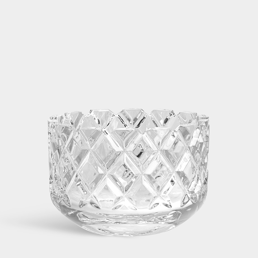 An Orrefors: Sofiero Bowl Medium, clear glass with a diamond-patterned design evoking Scandinavian classics, stands against a plain light backdrop.